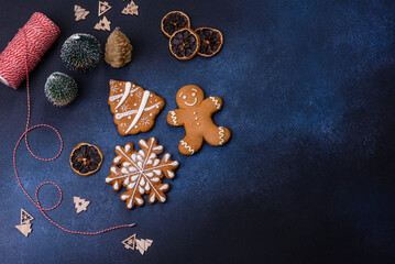 Christmas decorations and gingerbreads on a dark concrete table