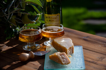 Cheese pairing with drinks,  parmigiano reggiano or parmesan cheese and French apple cider served outdoor