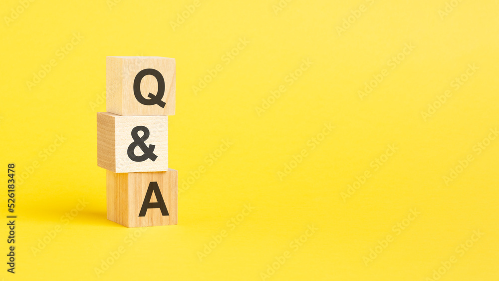 Poster q a - question and answer - text on wooden block with yellow background.