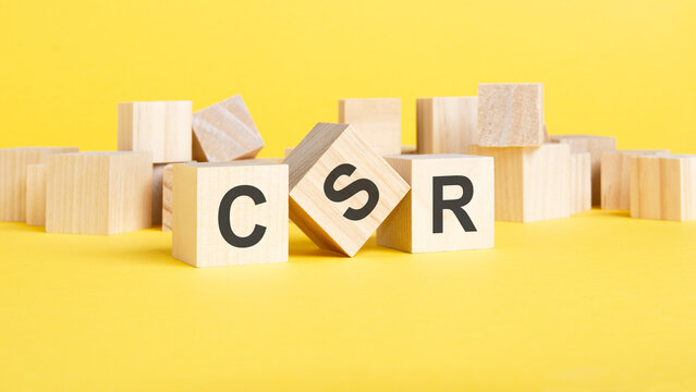 CSR, Corporate, Social, Responsibility symbol. wooden blocks with words csr concept