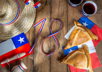 Chilean independence day concept. fiestas patrias. Tipical baked empanadas, wine or chicha, fat and...