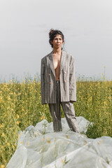 An Asian model poses in a field of yellow flowers for a clothing brand, polyethylene is the main...