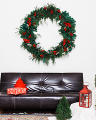 Christmas decoration set with a big wreath against a white wall