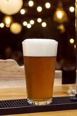 Craft beer served in a glass with foam. Nightlife