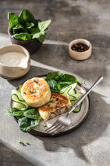 Potato patties Stuffed with meat, served with sour cream and vegetables. Traditional Ukrainian...