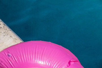 Pink float on the edge of a swimming pool