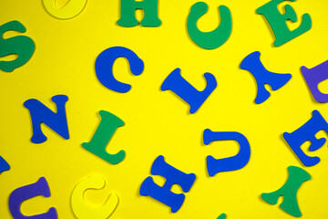 Colorful letters of the alphabet on yellow background.. Educational game. Learning through play. 