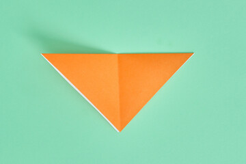 Origami Bear. Step-by-step photo instruction on a green background. DIY concept. Step3.