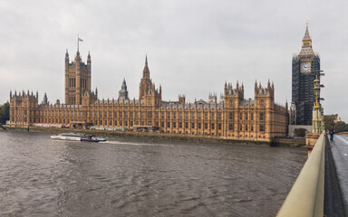 Palace of Westminster with the boat on the river Thames. The meeting place for houses of the...