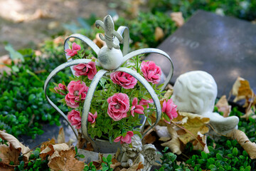 flowers in a crown as a grave arrangement in a cemetery