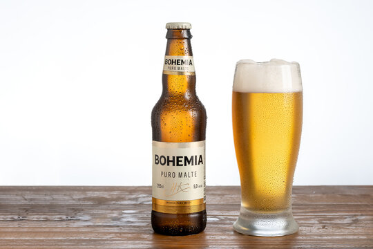 S&atilde;o Paulo, Brazil - August 26, 2022
Bohemia brand beer bottle and a glass with beer on a wooden board