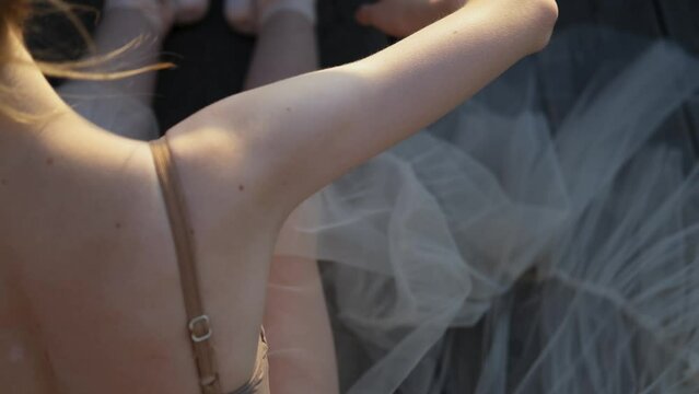 close-up of the back of a dancing young ballerina