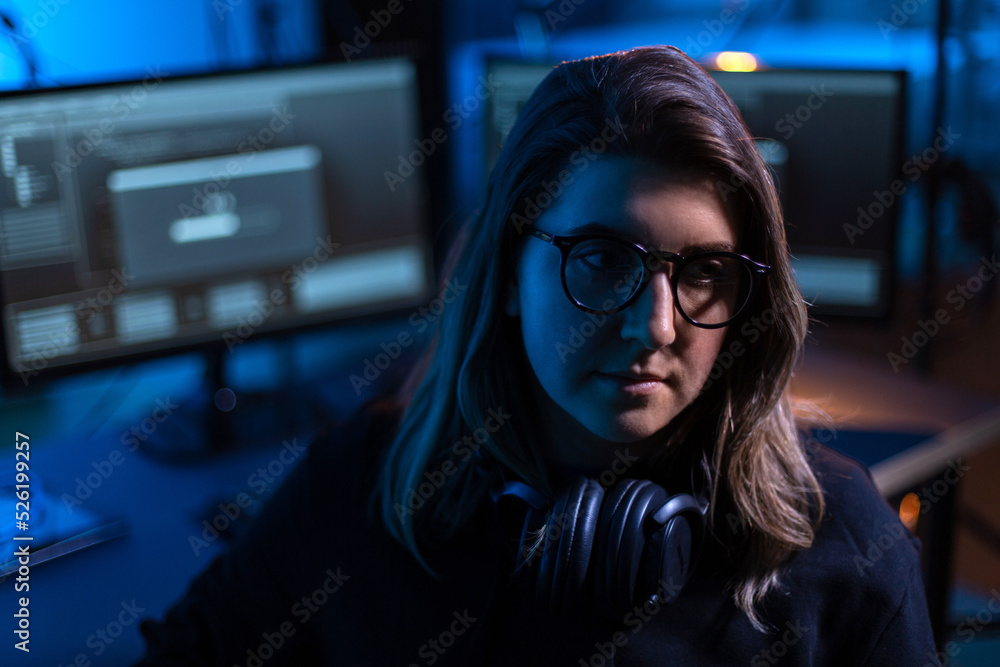 Poster cybercrime, hacking and technology concept - female hacker in dark room using computer virus program