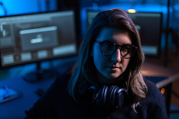 cybercrime, hacking and technology concept - female hacker in dark room using computer virus...