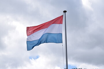 Luxembourg flag with a cloudy sky background. European Union country flag