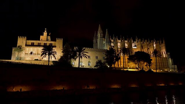 Night static shot of Cathedral (La Seu) and Royal Palace (Almudaina) - Palma de Mallorca, Spain.
