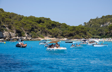 Fototapeta na wymiar Menorca, Spain: Beautiful bay with sailing boat catamaran