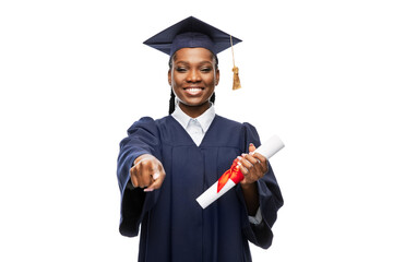 education, graduation and people concept - happy graduate student woman in mortarboard and bachelor...