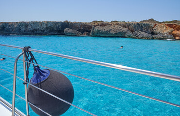 Menorca, Spain: Beautiful bay with sailing boat catamaran