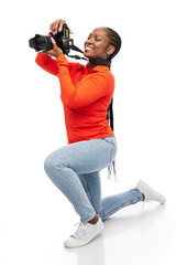 people, profession and photography concept - happy smiling woman photographer with digital camera...