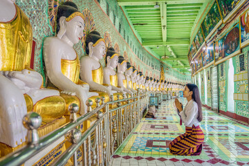 Myanmar woman praying at Umin Thonze Pagoda Sagaing hill Mandalay Myanmar