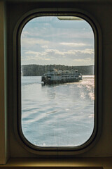 Obraz na płótnie Canvas Viewing a ferry boat through a passing ferry boat window