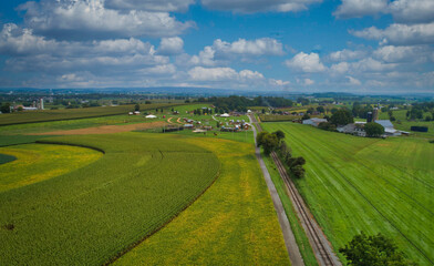 Drone View of Amish Countryside With Barns and Silos and Corn, Patch Work of Color and Corps, on Sunny Day.