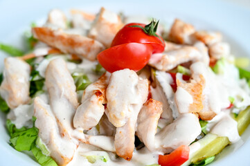 Chicken salad served on the table in restaurant. Chicken meat for lunch.