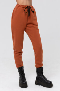 Brown jogger pants mockup. Template sports trousers front view for design. Fitness wear isolated on white