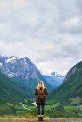 Travel adventure woman enjoying view of majestic glacial valley on exploration discover beautiful...