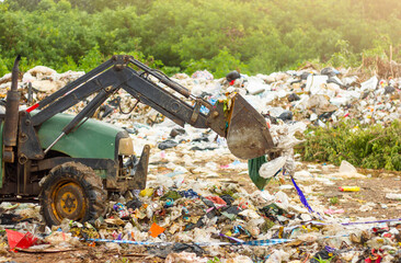 backhoe plow in garbage dump
