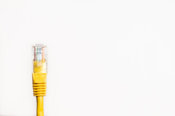 Yellow network cable on white background with space for text.