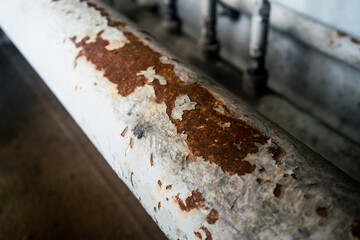 Steel pipe clamp with anti-rust paint peeling off the pipe surface.