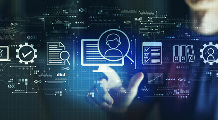 Fototapeta premium Document management system concept with young man touching a digital screen at night