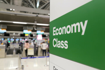 Counter check in or registration desk for Economy class at the international airport with crowd control barriers before boarding to an airplane. concept of air travel business.