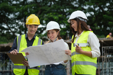 Team of architect checking plans at the construction site. Engineering and architecture concept.