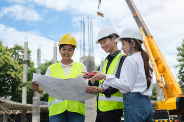 Civil engineer team in protective helmets and vests inspecting construction site. Engineering and...