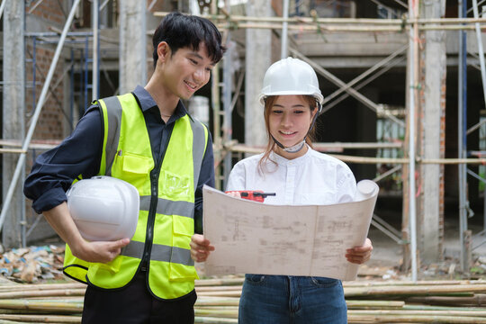 Shot of engineer discussing the structure of the building with architect at construction site.