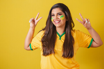 Woman supporter of Brazil, world cup 2022, football championship, With peace and love sign with...