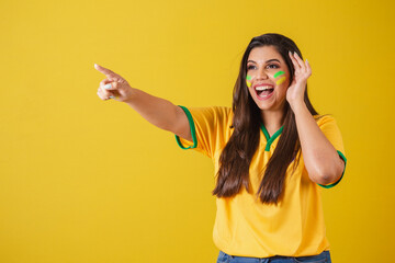 Woman supporter of Brazil, world cup 2022, football championship, surprised, amazing, pointing away...