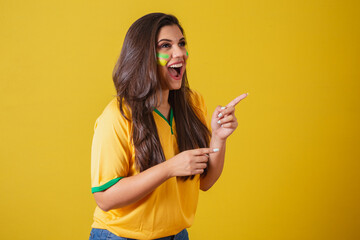 Woman supporter of Brazil, world cup 2022, football championship, surprised, amazing, pointing away...