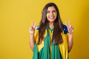 Woman supporter of Brazil, world cup 2022, soccer championship, using brazil flag as cover. Peace and love.