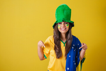 Woman supporter of Brazil, world cup 2022, pointing with fingers, only here, announcing here.