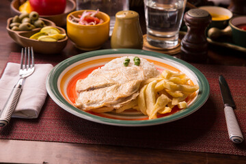 Fried chicken filet with french fries and rice peruvian gourmet restaurant comfort food