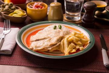 Fried chicken filet with french fries and rice peruvian gourmet restaurant comfort food