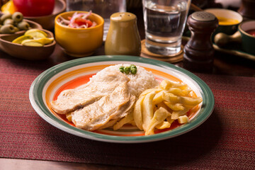 Fried chicken filet with french fries and rice peruvian gourmet restaurant comfort food
