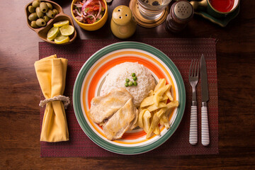 Fried chicken filet with french fries and rice peruvian gourmet restaurant comfort food
