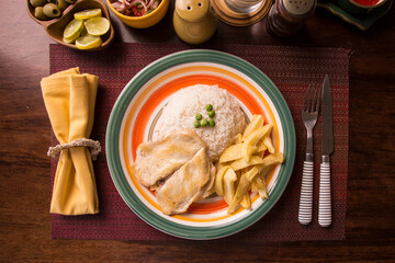 Fried chicken filet with french fries and rice peruvian gourmet restaurant comfort food