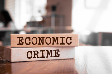 Economic Crime text concept written on wooden blocks lying on a table