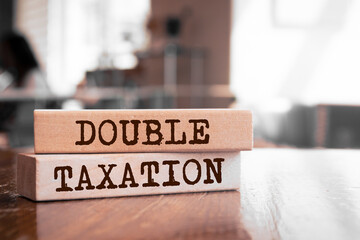 Double Taxation text concept written on wooden blocks lying on a table